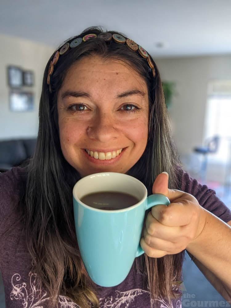 Becca drinking a cup of coffee